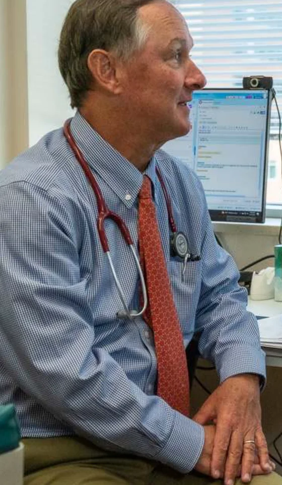 A physician at a desk during a visit
