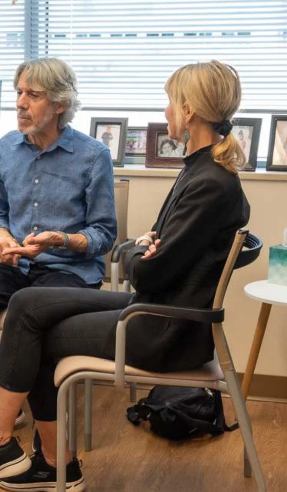 A physician in conversation with a couple in the office