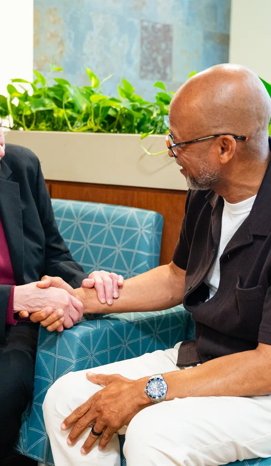 A physician welcoming a patient at a visit