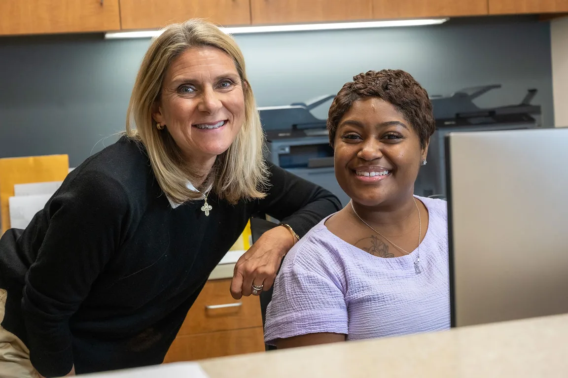 Two members of the practice staff at the front desk